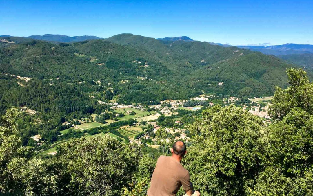 Randonneur contemplant le paysage cévenol sur le rocher d'escorce à Saint Jean du Gard